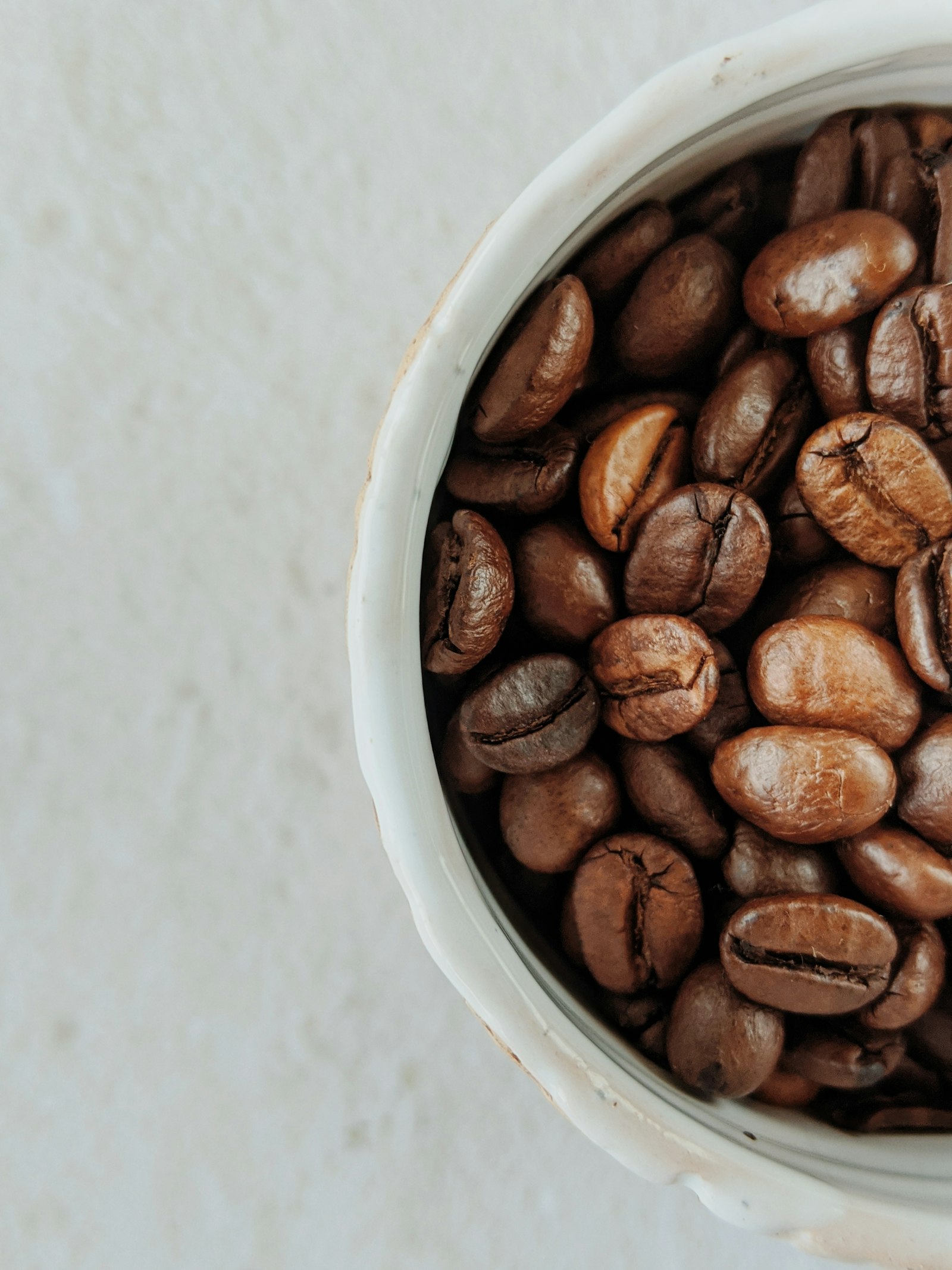 Roasted coffee beans in a ceramic vessel